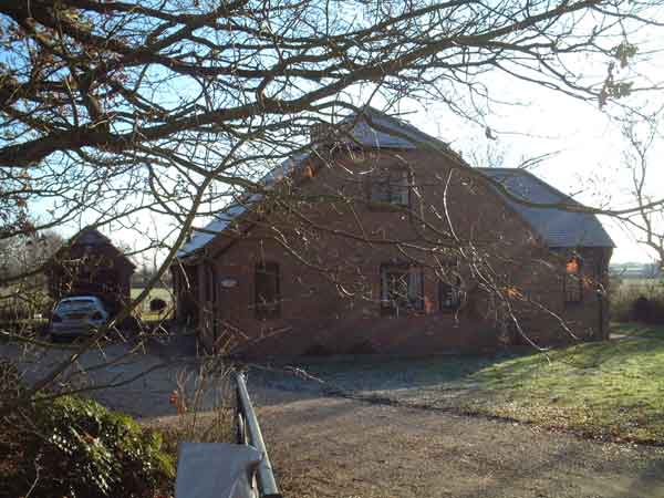 Farmhouse through trees